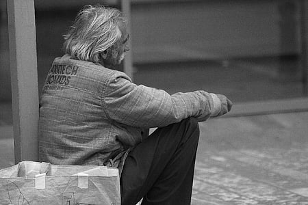 grayscale photo of man sitting wearing jacket thumbnail
