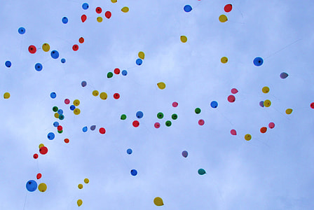 assorted balloons on mid air under cloudy sky during daytime thumbnail