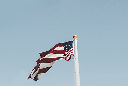 United States of America flat on white pole taken during daytime thumbnail