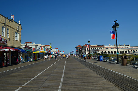 group of people walking on gray wooden road thumbnail