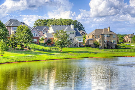 village houses near body of water during daytime thumbnail