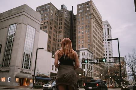 woman standing on the street during daytime thumbnail