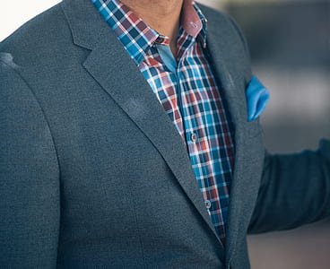 close view of man wearing grey suit jacket thumbnail