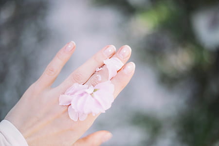 selective focus photography of person wearing pink ring thumbnail