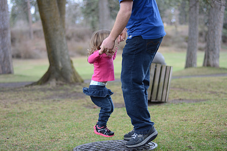 man holding girl in pink long-sleeved shirt thumbnail