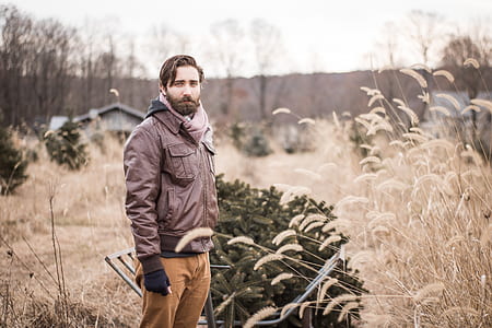 man wearing jacket near plant thumbnail