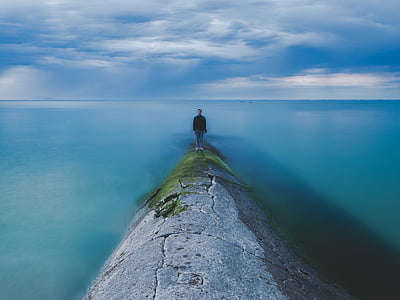 man standing near body of water thumbnail