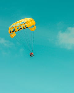 three people riding yellow parachute thumbnail