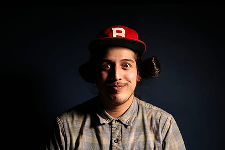 Man Wearing Red Fitted Cap and Brown and Gray Plaid Collared Hsirt thumbnail