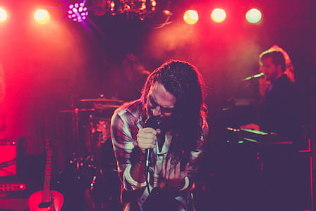 man singing with band on stage thumbnail