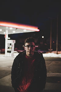 man standing near gasoline station thumbnail
