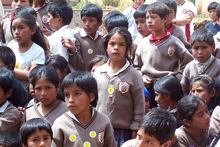 selective focus photography of girl standing outside with students during daytime thumbnail