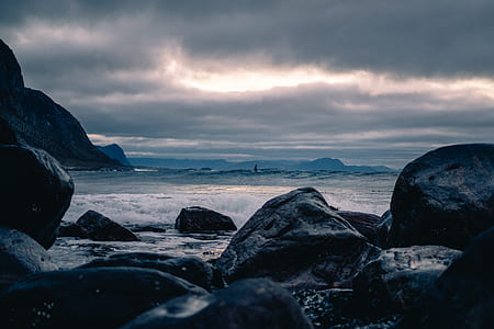 rocks near body of water during daytime thumbnail