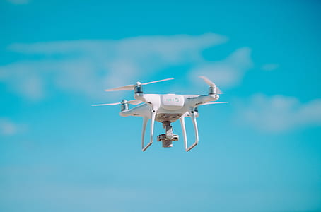 white quadcopter drone on sky thumbnail