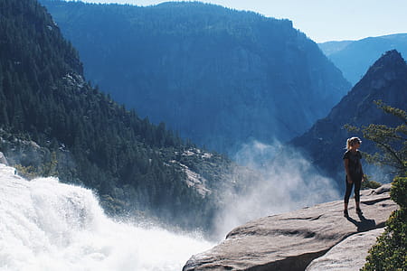 Woman Standing Near Mountain Cliff thumbnail