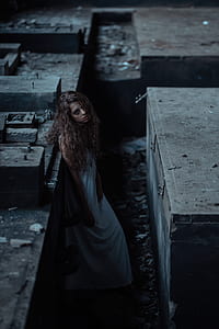 woman standing beside concrete brick thumbnail
