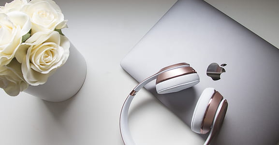 rose gold Beats cordless headphones on silver MacBook thumbnail