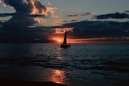 Silhouette of Sailboat on Body of Water during Sunset thumbnail