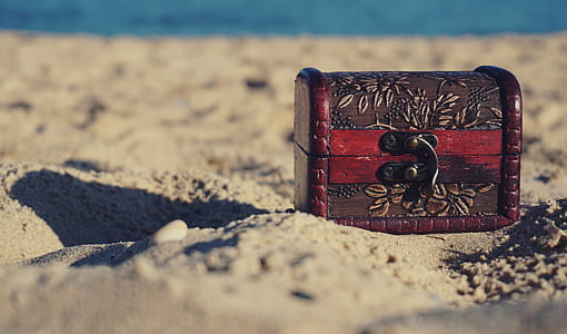 Red and Black Wooden Chest on White Sand thumbnail
