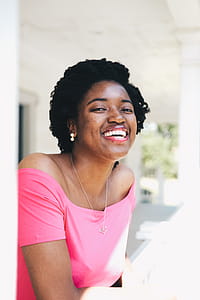 Smiling Woman Wearing Pink Off-shoulder Top thumbnail