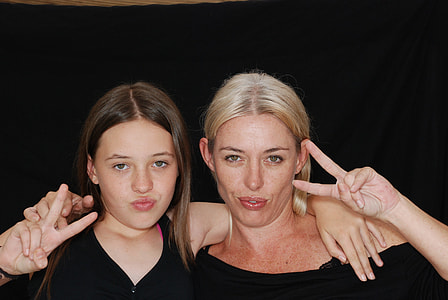 two women in black dresses showing hand gesture thumbnail