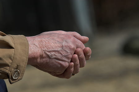 Man in Brown Dress Shirt Clasp Both Hands thumbnail