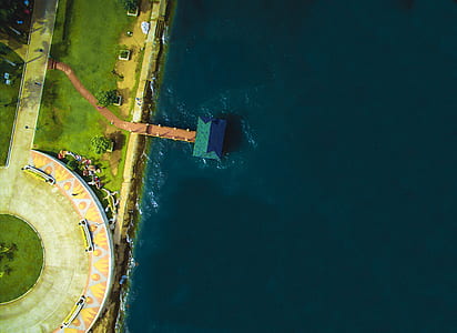 aerial view photography of green house on body water thumbnail
