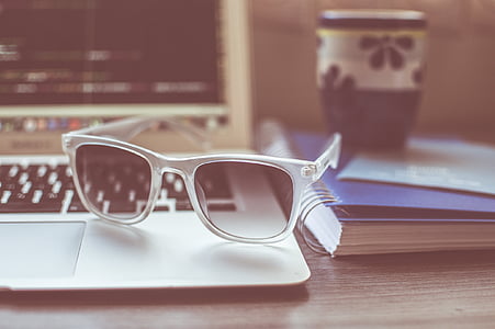 selective focus photograph of acrylic framed sunglasses on MacBook Air near notebook thumbnail