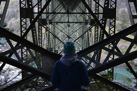 person standing in front of black metal frames thumbnail