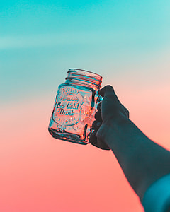 person holding clear glass mug thumbnail