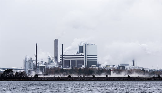 buildings beside ocean under cloudy sky thumbnail