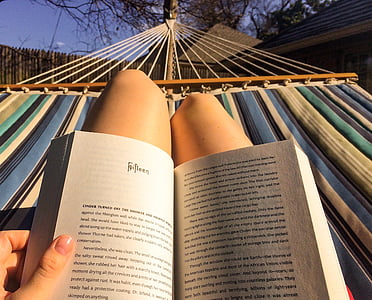person on blue, gray, and green striped hammock thumbnail