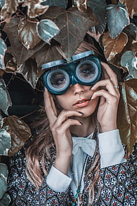 woman wearing eyeglasses in the middle of brown leaves thumbnail