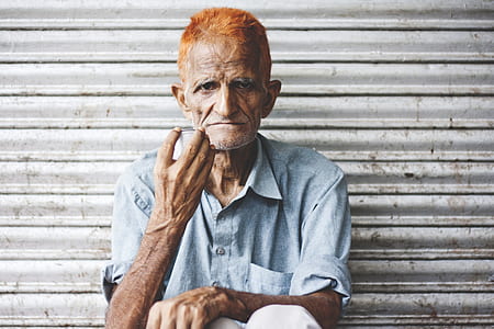man sitting front of roll up gate thumbnail