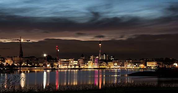 lighted concrete buildings at night thumbnail