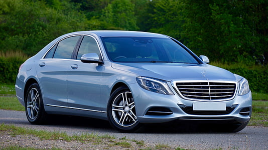 blue Mercedes-Benz sedan parked near trees thumbnail