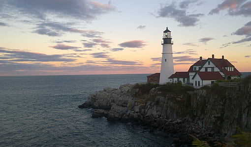 white lighthouse near body of water thumbnail