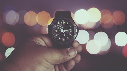 person holding analog watch thumbnail