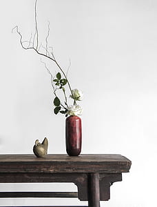 white roses centerpiece on brown wooden shelf thumbnail