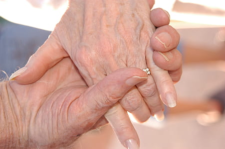 selective focus photography of person holding hands together thumbnail