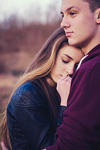 man hugging woman in black leather jacket thumbnail