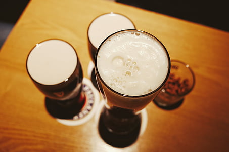 four drinking cups on top of brown wooden table thumbnail
