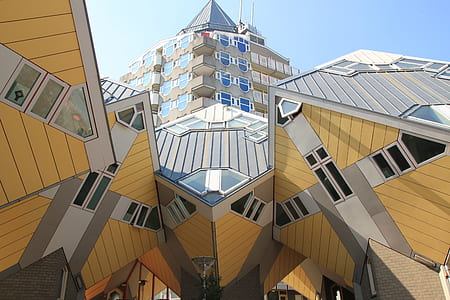 low angle photo of brown and grey glass building under clear sky thumbnail
