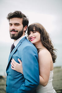 selective focus photo of groom and bride smiling while standing during daytime thumbnail
