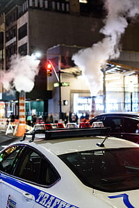 white police car near on road at night thumbnail