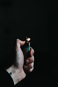 person using teal lighter thumbnail