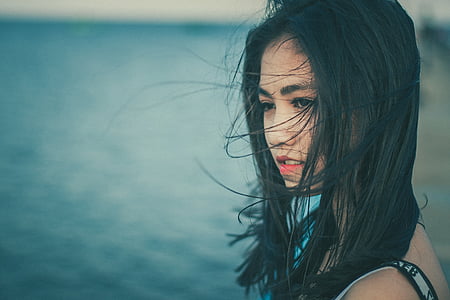 black haired woman wearing black and gray sleeveless top thumbnail