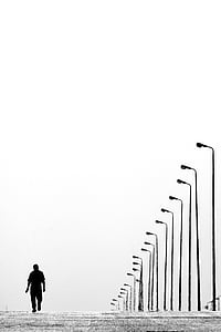 man waling on the street during daytime thumbnail
