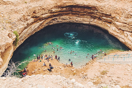 group of people swimming in cavern with lake thumbnail