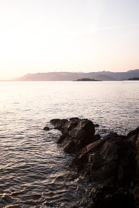 panoramic photo of mountain surrounded by island thumbnail
